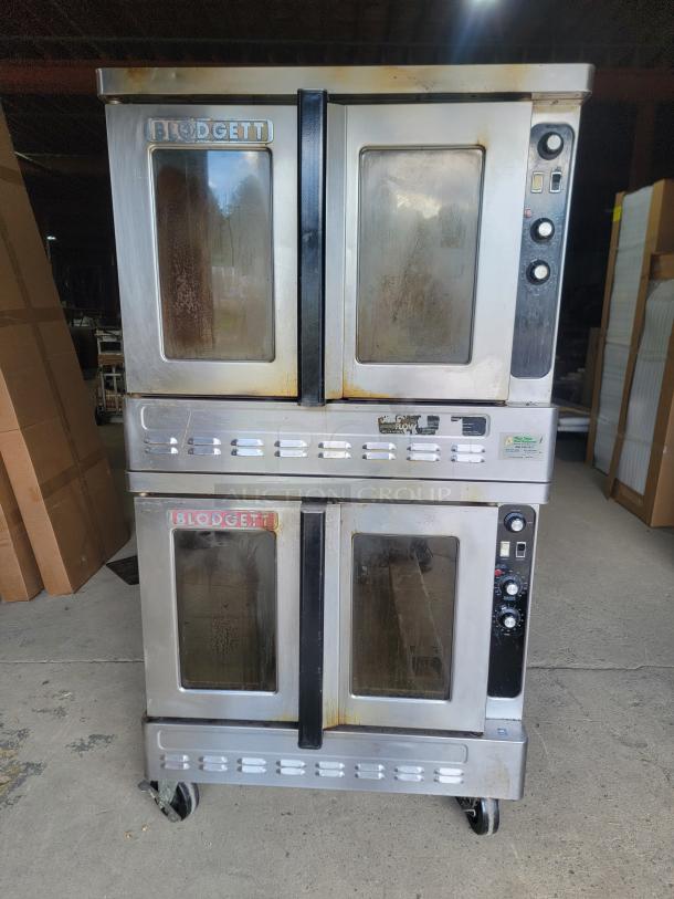 Blodgett DFG-100/200 double convection oven in stainless steel. Features control dials, visible wear, and glass doors. Ideal for commercial use.