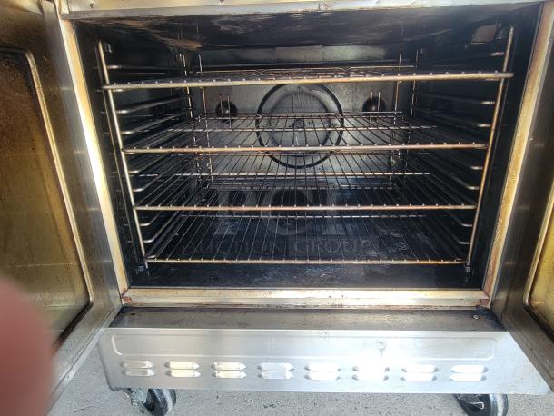Blodgett DFG-100/200 double convection oven, stainless steel, multiple racks, industrial wheels, used condition.