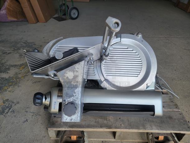 Hobart Model 3913 commercial meat slicer, heavy-duty, showing blades and controls, in good condition, on a wooden pallet.