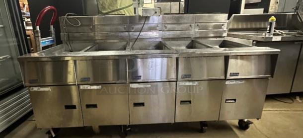 Pitco SSHBN55 4-bank fryer battery with dump and filter system, stainless steel, ideal for high-volume kitchens, good condition.