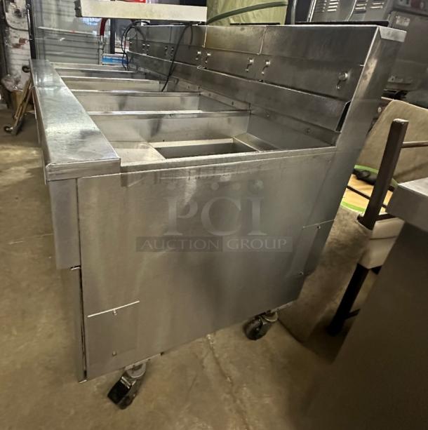 Pitco SSHBN55 4-bank fryer battery with dump and filter system, ideal for high-volume kitchens, shown in good condition.