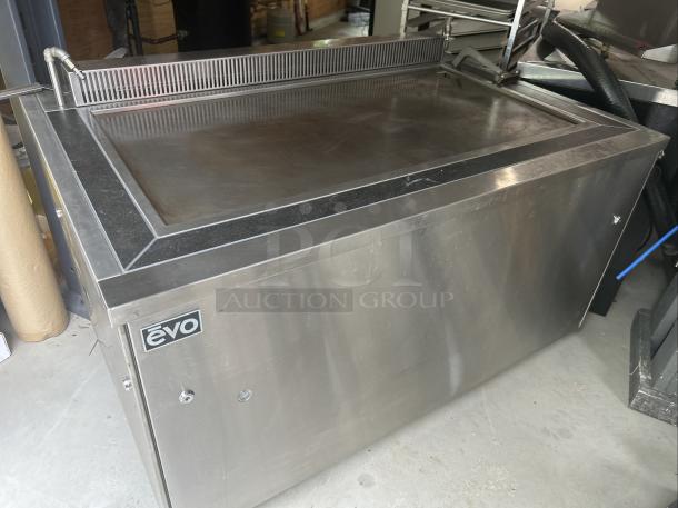 Evo 48" electric griddle, model 48E-10-0148-EVT, with metal surround. Features ventless design, sleek stainless steel finish.