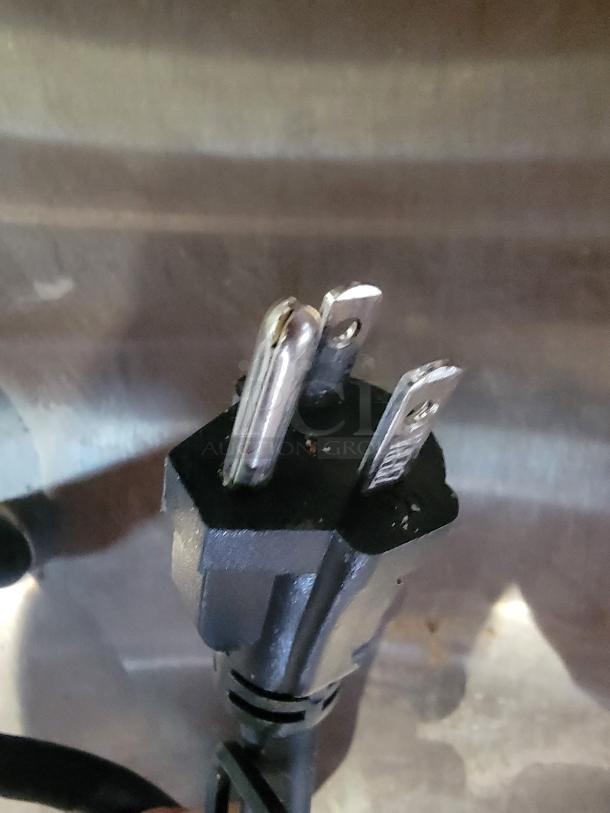 Close-up of a power plug from the Waring Commercial Panini Press, model WPG250, showing three prongs.
