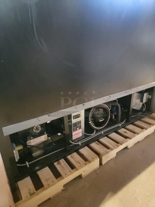 RPI Industries SCRFC7278R Air Screen Merchandiser on wooden pallets. Features LED lighting and a Roll Down night shield.