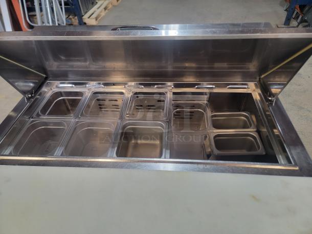 Turbo Air 36" refrigerated prep table on casters, model MTS-36-NS, with multiple insert bins for cold ingredient storage.