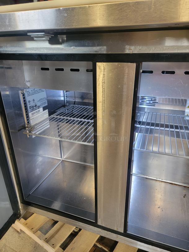 Turbo Air refrigerated 36" prep table, Model MTS-36-NS. Stainless steel interior, clean shelves, on casters for mobility.