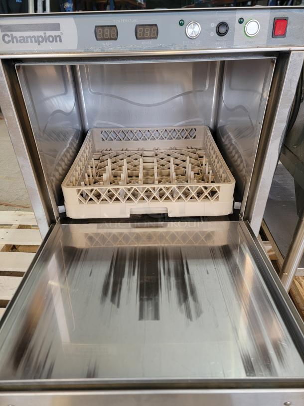 Champion UH130B commercial dishwasher, stainless steel, digital controls, open door showing rack. High-temp sanitize feature.