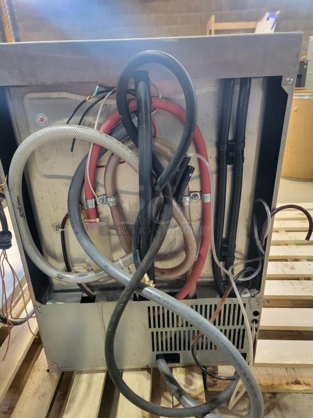 Champion UH130B commercial dishwasher back view showing hoses and connections. High-temp sanitize feature, ideal for compact spaces.