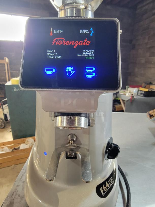 Fiorenzato F64 Evo espresso grinder with digital display showing temperature and settings. Commercial-grade, sleek design.