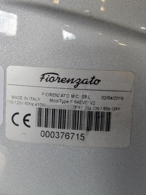 Fiorenzato F64 Evo espresso grinder label showing model F64EVC V2, 110-120V, 410W, made in Italy, with serial number 000376715.