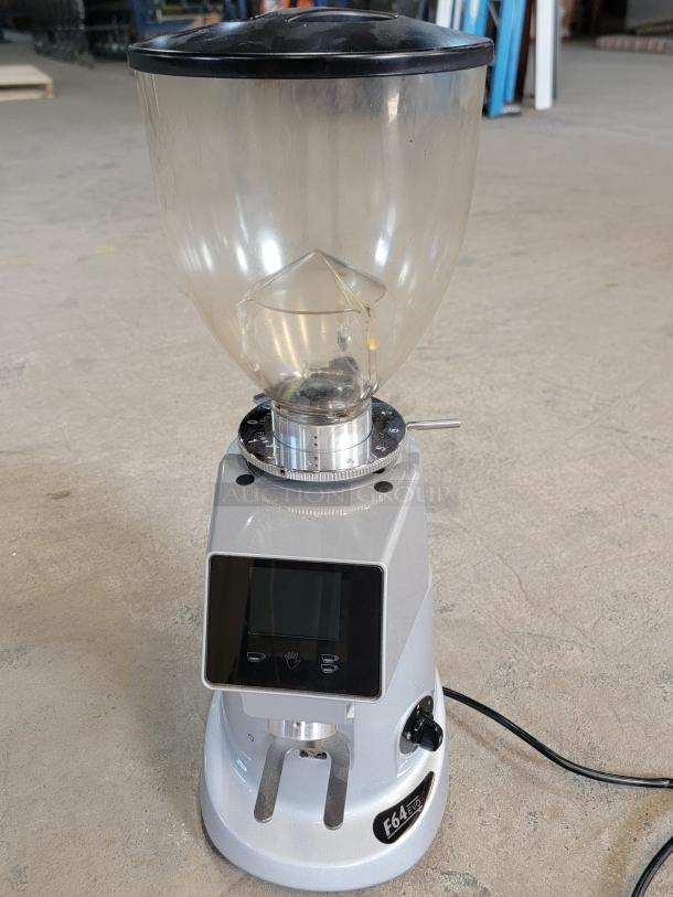 Fiorenzato F64 Evo espresso grinder with digital display, intact hopper, and F64 Evo labeling. Ideal for precise, commercial use.