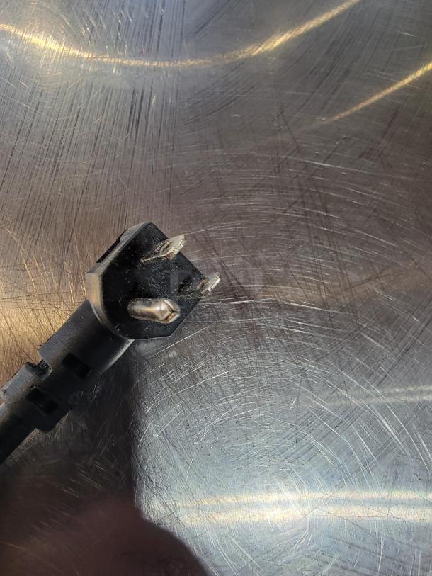 Continental SW48N 48" worktop refrigerator plug on a stainless steel surface, showing light wear.