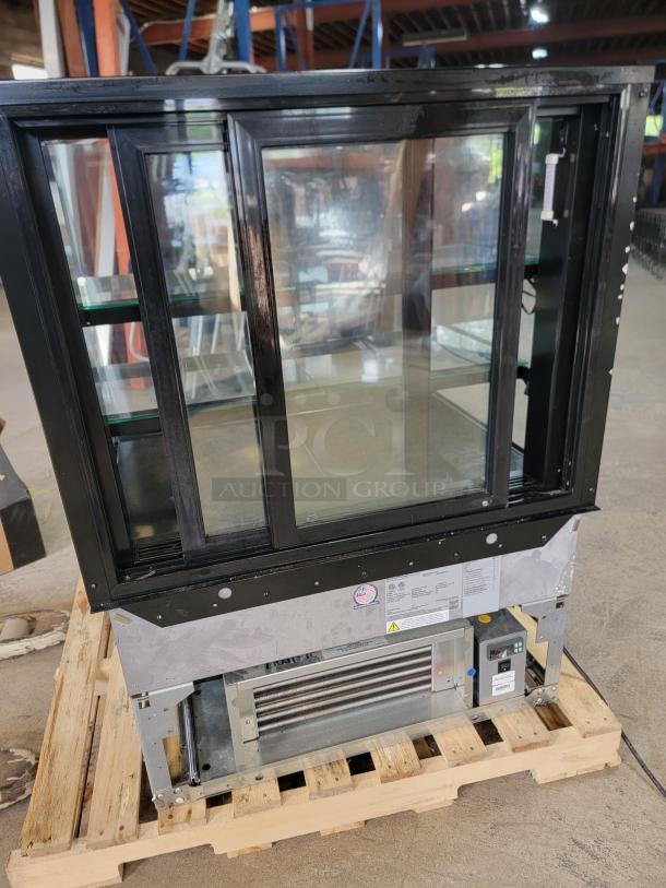 Structural Concepts Reveal NE3627RSV refrigerated display case, tested and working, black frame, ideal for food display.