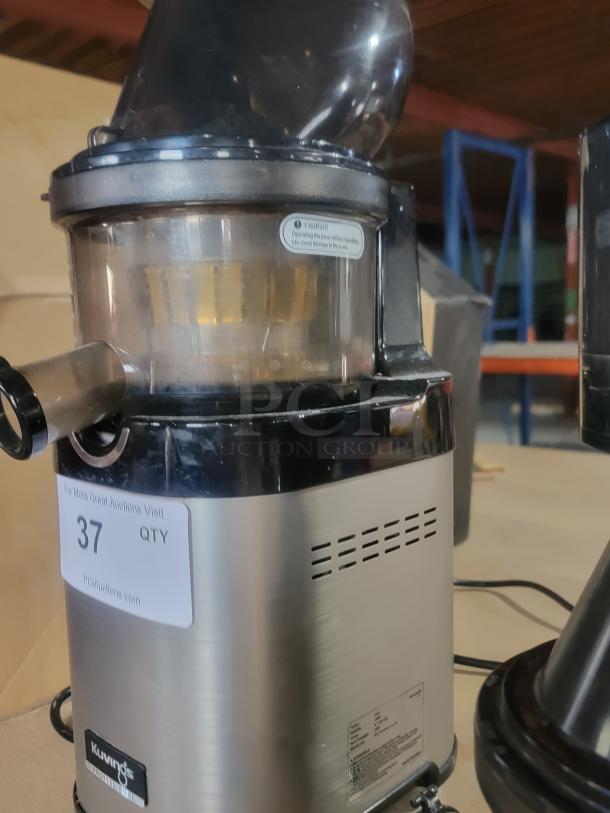 Kuvings CS600 commercial cold press juicer in stainless steel, showing motor base with product label and juice spout.
