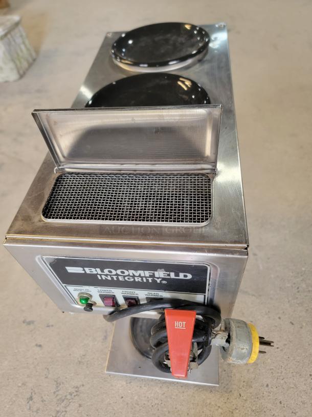 Bloomfield Integrity 9003 commercial coffee maker in good condition. Features control panel, dual warmers, and a power cord with a "HOT" tag.