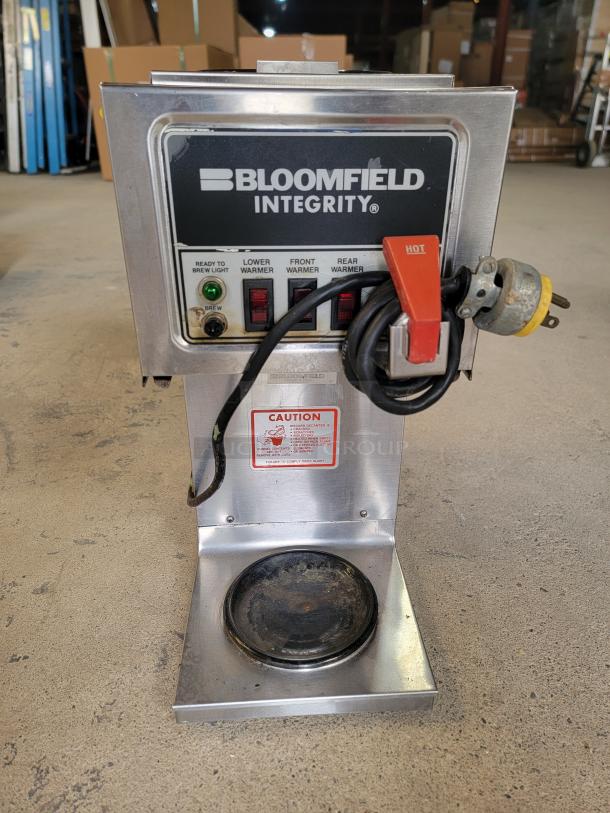Bloomfield Integrity 9003 commercial coffee maker, stainless steel, user-friendly controls, visible wear, caution label, reliable performance.