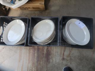 Large lot of Homer Laughlin ivory platters with rolled edges in crates, ideal for commercial use. Original price $340/dozen.