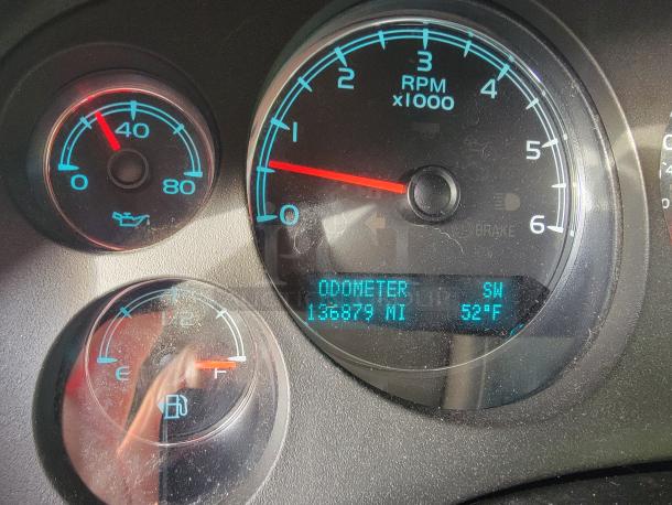 Dashboard of a 2012 Chevy Tahoe 4x4, showing odometer at 136,879 miles and temperature at 52°F. RPM, fuel, and oil gauges visible.