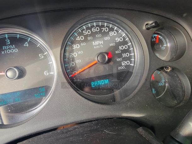 Close-up of 2012 Chevy Tahoe dashboard showing odometer at 136,873 miles, speedometer, and RPM gauge.