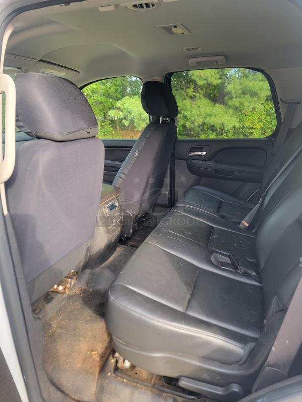 Interior view of a 2012 Chevy Tahoe 4x4 SUV. Black leather seats and well-maintained cabin visible.