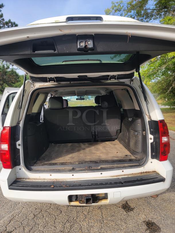 White 2012 Chevrolet Tahoe 4x4, rear view with tailgate open. Spacious cargo area, fleet-maintained. 136,880 miles.