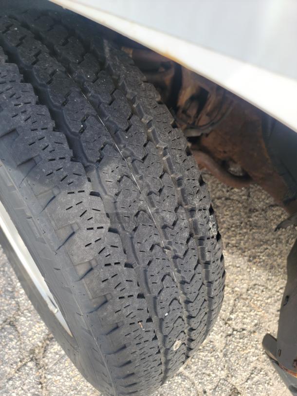 Close-up of a tire from the 2012 Chevy Tahoe. It shows detailed tread pattern and slight wear, indicating good condition.