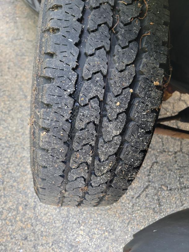 Close-up view of a well-maintained tire on a 2012 Chevy Tahoe 4x4, showcasing its tread pattern and condition.