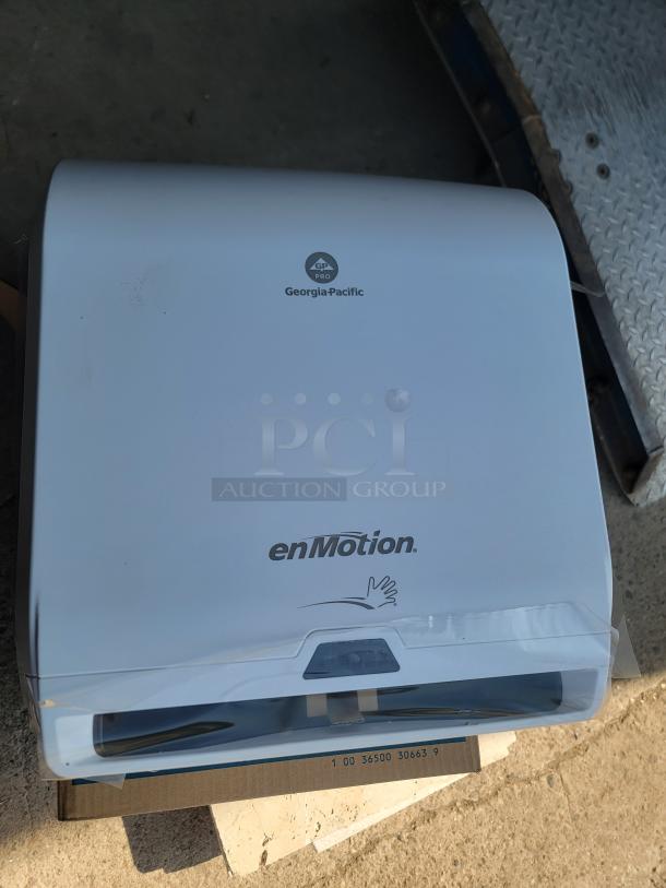 Brand new Georgia-Pacific enMotion 59407A automated touchless paper towel dispenser, shown in packaging.