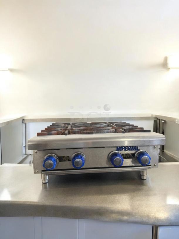Imperial 4-Burner Gas Hot Plate in excellent condition, natural gas, fully tested, stainless steel, blue knobs, model labeled.