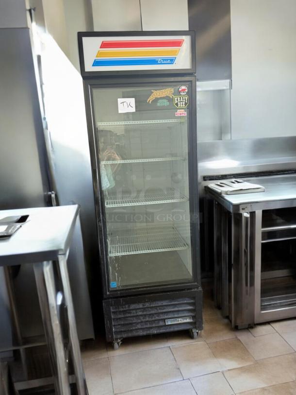 True QDM-23-HC glass door refrigerator, excellent condition, 1-door upright, 115V. Features include colorful top display and interior shelving.