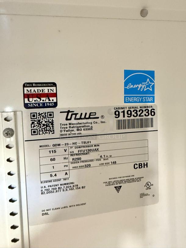 True QDM-23-HC Glass Door Merchandiser Refrigerator label; 115V, tested, Energy Star, Made in USA, model info visible.