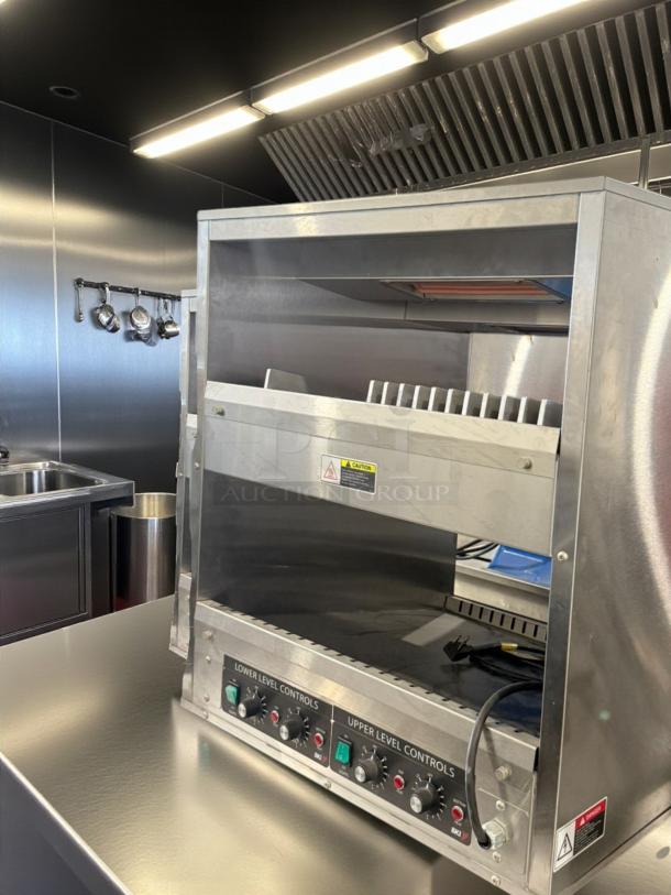 Dual-level electric cheese melter, excellent condition, 120V, fully tested. Features upper and lower controls, stainless steel finish.
