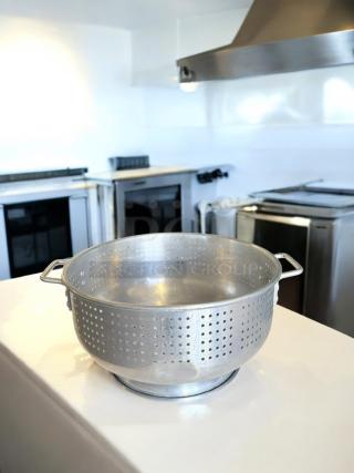 Heavy-duty aluminum colander in excellent condition, commercial model. Features perforated sides and sturdy handles.