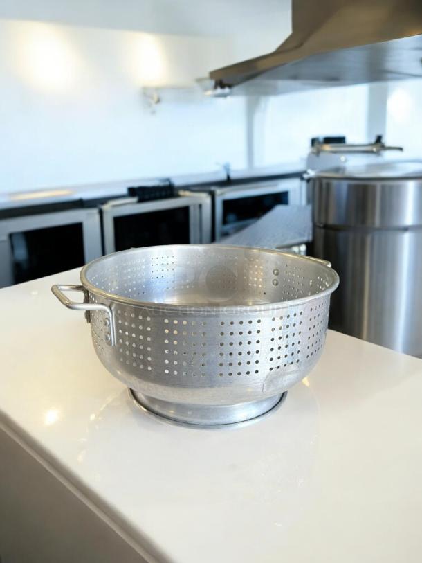 Heavy-duty aluminum colander in excellent condition, commercial model; fully tested, features side handles and perforated design.