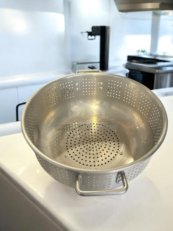 Excellent condition commercial aluminum colander, heavy-duty, fully tested, with dual handles and perforated design.