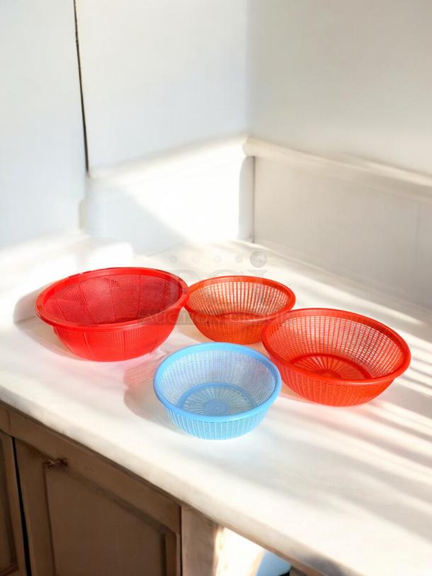 Set of 3 plastic kitchen basket strainers in excellent condition, includes red and blue strainers in varying sizes.