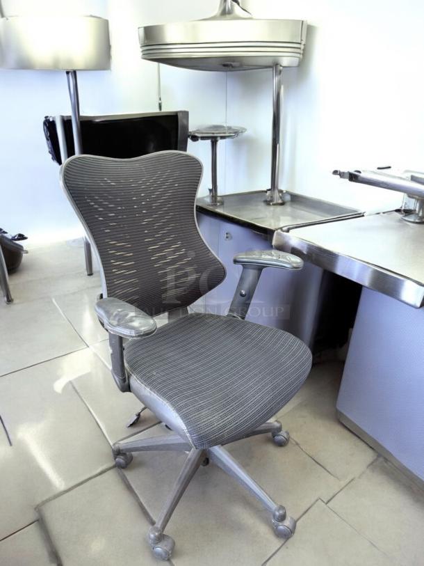 Ergonomic Mesh Back Task Chair in excellent condition; features adjustable armrests, mesh back, wheeled base, fully tested.