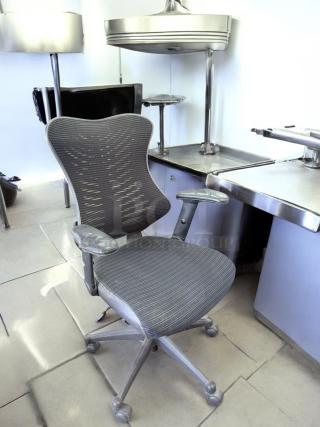 Ergonomic Mesh Back Task Chair in excellent condition; features adjustable armrests, mesh back, wheeled base, fully tested.