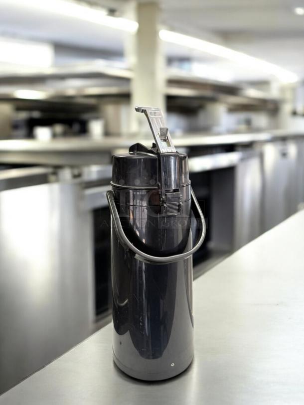 Black plastic airpot coffee dispenser, 2.5L capacity, excellent condition, tested and working, Generic Commercial brand.