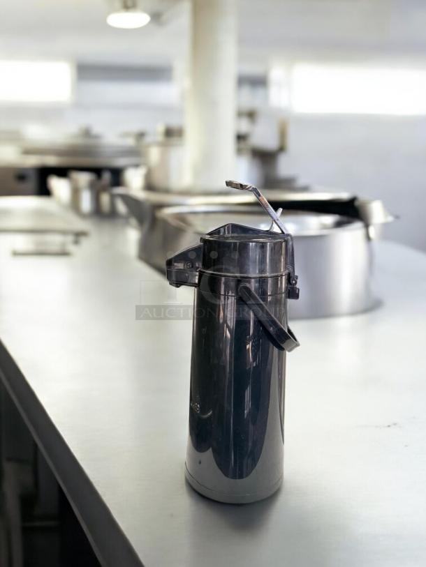 Black plastic airpot coffee dispenser, 2.5L by Generic Commercial. Excellent condition, fully tested and functional.