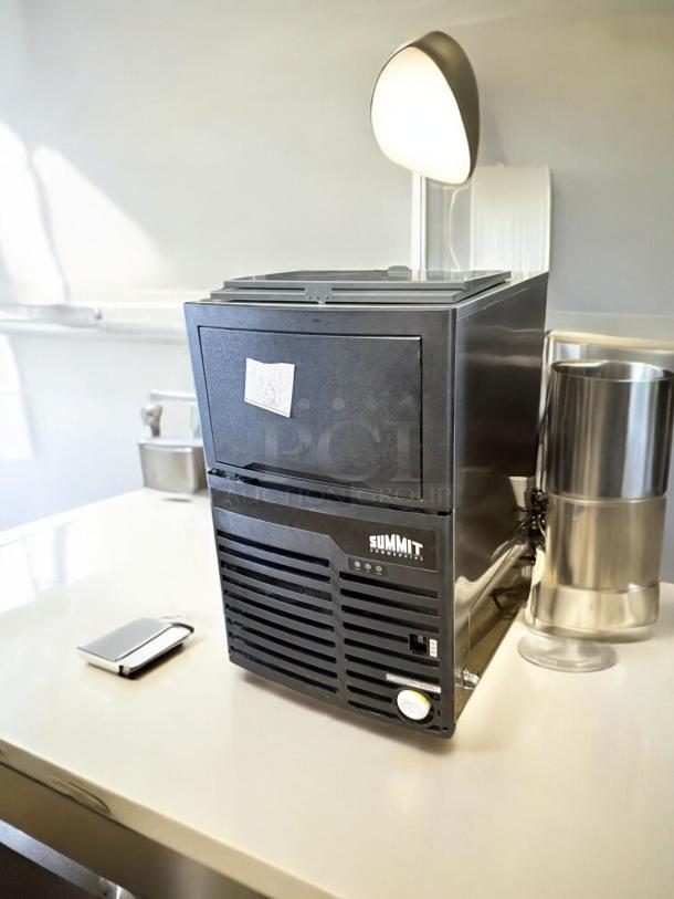 Summit BIM100 commercial ice maker, excellent condition, fully tested, 115V, black finish, front label shows Summit logo.