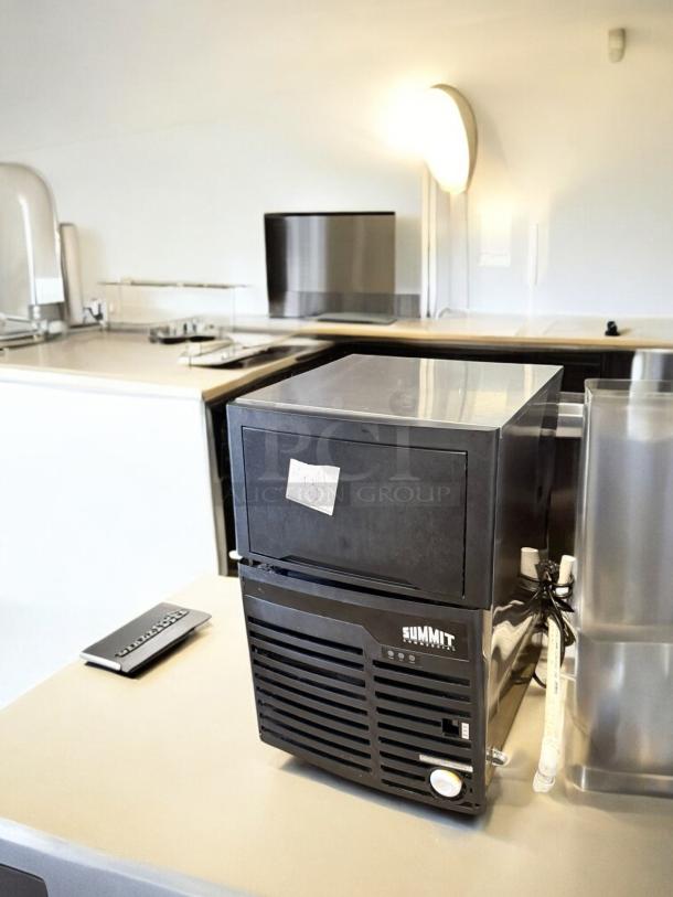 Summit BIM100 Commercial Ice Maker in excellent condition, fully tested and working, 115V, black exterior with label, model BIM100/SCIM100/ALIM100.