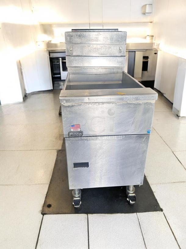 Pitco SG18S gas fryer in excellent condition, 65 lb capacity, natural gas, fully tested. Visible Pitco label and American flag sticker.