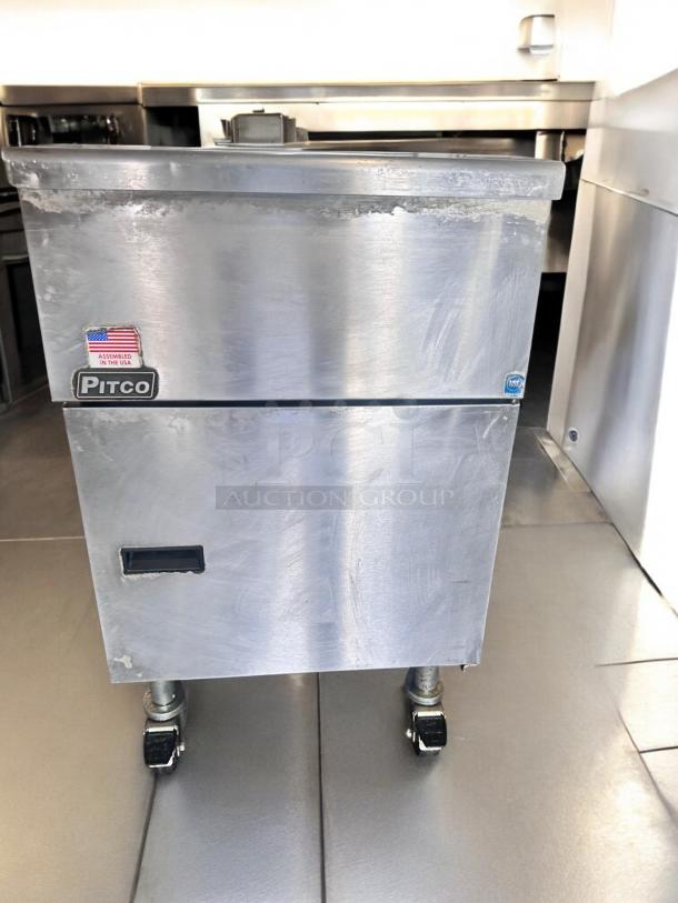Pitco SG18S gas fryer, 65 lb capacity, natural gas, excellent condition. Features tags indicating assembly in the USA.