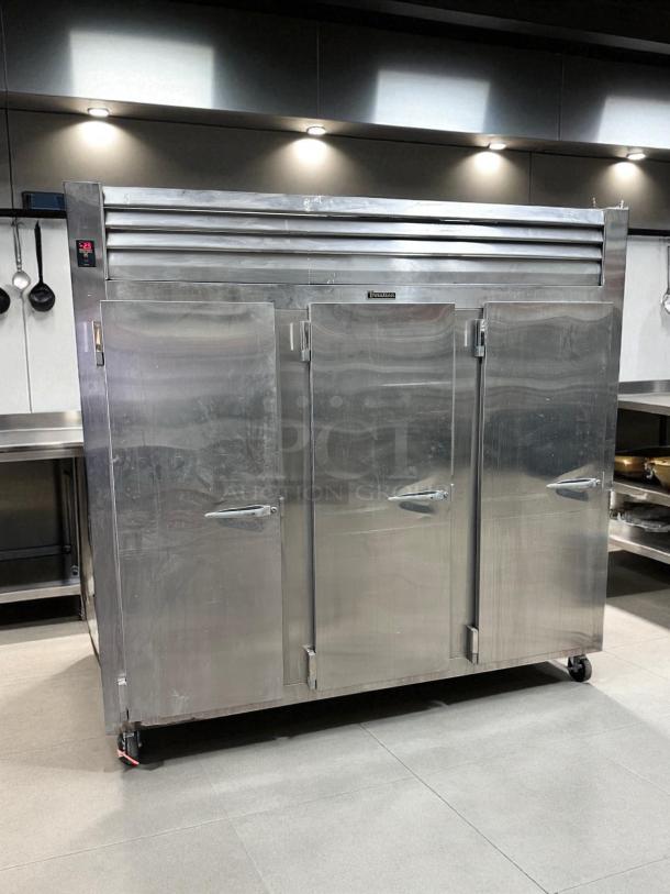 Traulsen 3-Door Commercial Freezer, Model RLT332WUT-FHS, in excellent condition; stainless steel body, fully tested.