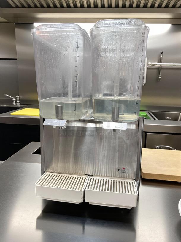 Crathco D25-3 cold beverage dispenser in excellent condition, fully tested and operational. Dual clear containers, stainless steel base.