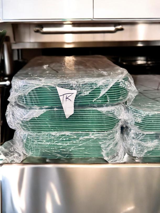 Cambro Camtray® green food service trays, model 23-3, stacked, wrapped in plastic. Excellent condition, NSF certified.