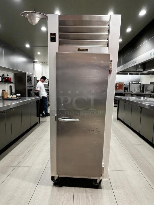 Traulsen G12010 commercial freezer in excellent condition, with front door, digital control panel, and Traulsen logo badge.