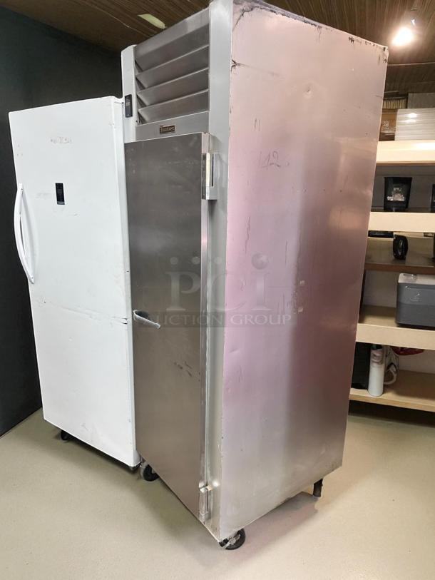 Traulsen Commercial Freezer, Model G12010, excellent condition, stainless steel, fully tested, visible brand label, on casters.