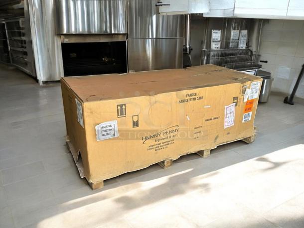 Brand new factory-sealed Henny Penny HHC900.24 full-height heated holding cabinet in box with handling labels.
